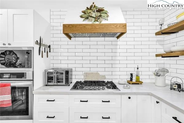 a white stove top oven sitting inside of a kitchen