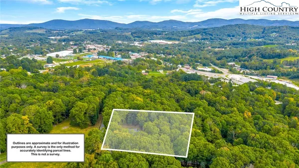 a view of a lush green hillside and houses