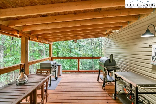 a view of balcony with wooden floor and outdoor seating