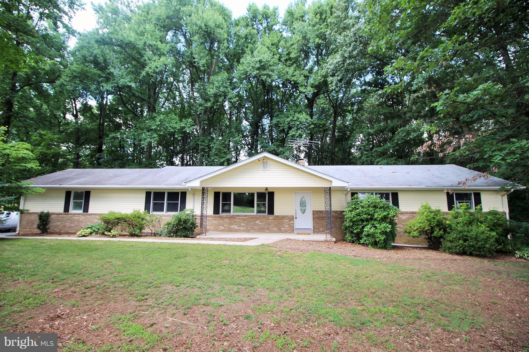 12919 Old Annapolis Road Mount Airy, MD 21771 - Photo 1 of 30 a front view of a house with a yard and trees