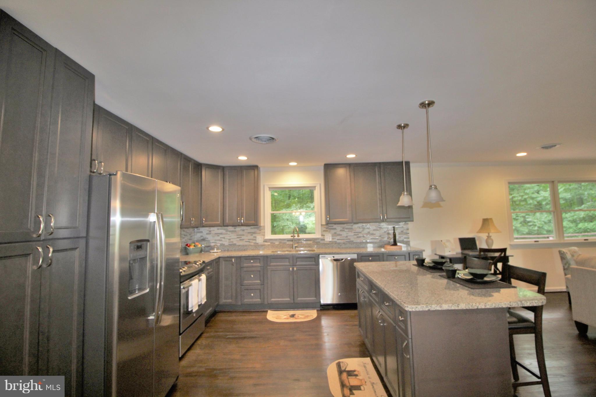 12919 Old Annapolis Road Mount Airy, MD 21771 - Photo 10 of 30 a kitchen with a sink a refrigerator and cabinets