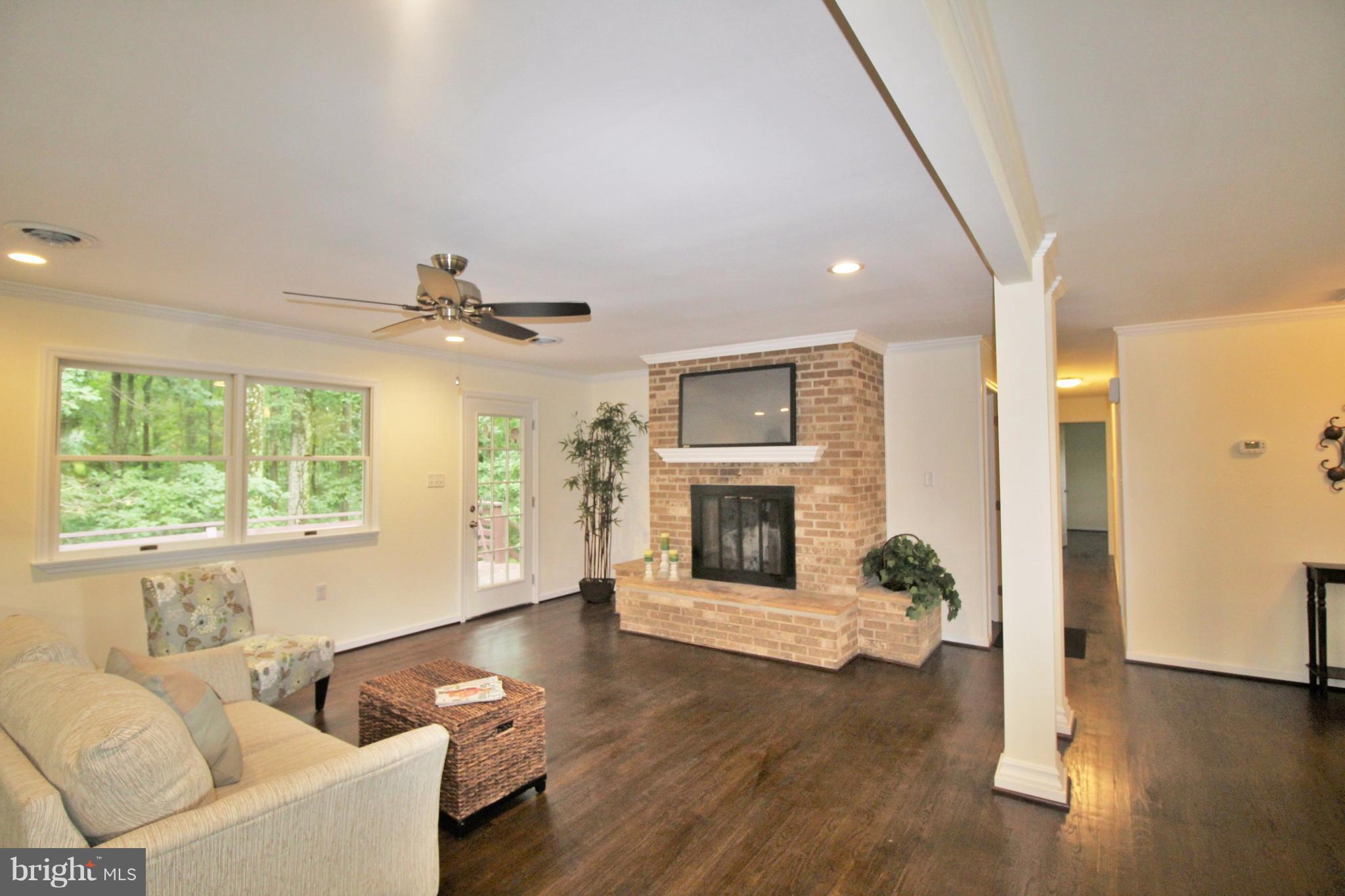 12919 Old Annapolis Road Mount Airy, MD 21771 - Photo 11 of 30 a living room with furniture and a fireplace