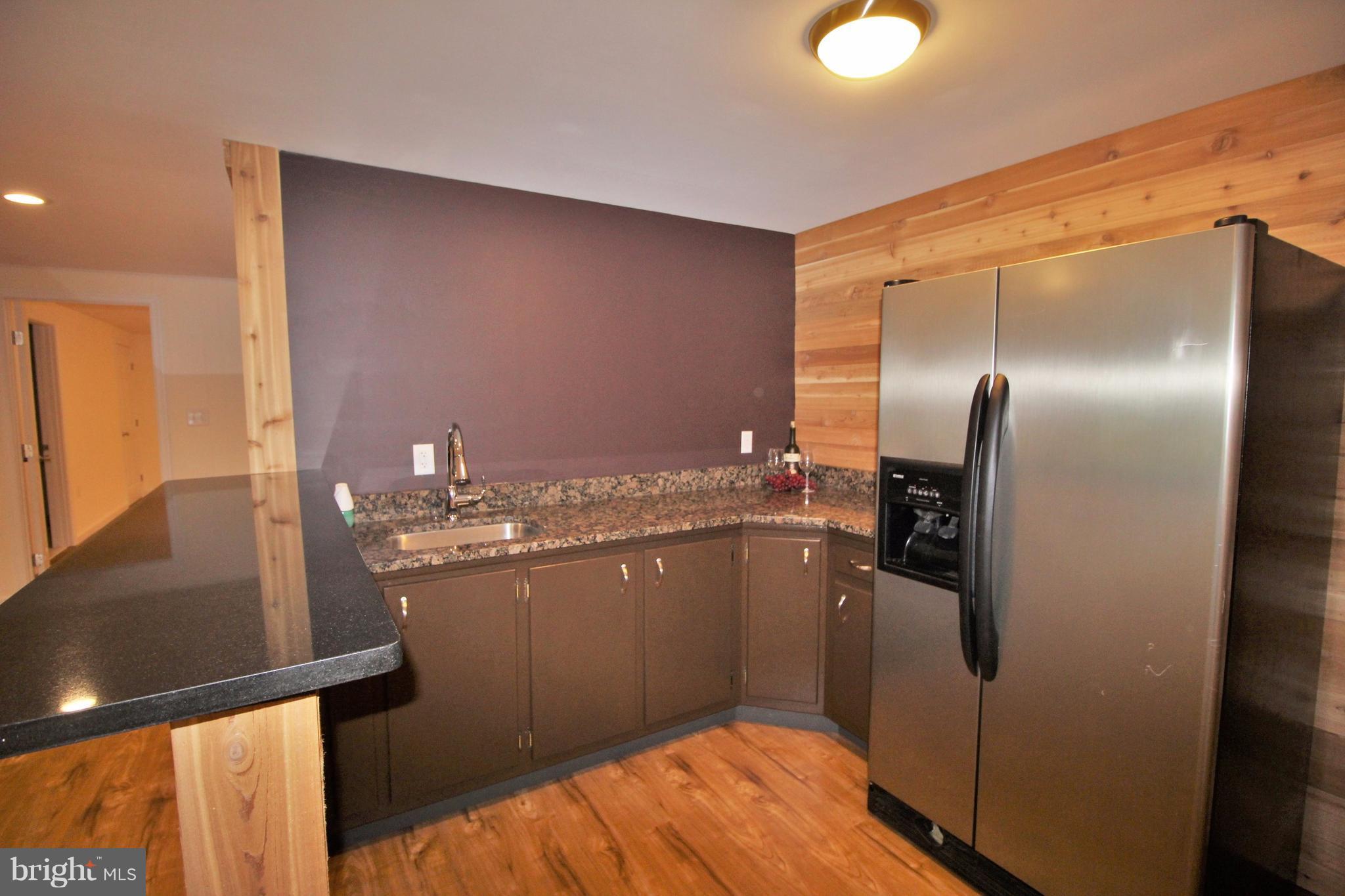 12919 Old Annapolis Road Mount Airy, MD 21771 - Photo 21 of 30 a kitchen with stainless steel appliances granite countertop a refrigerator and a sink