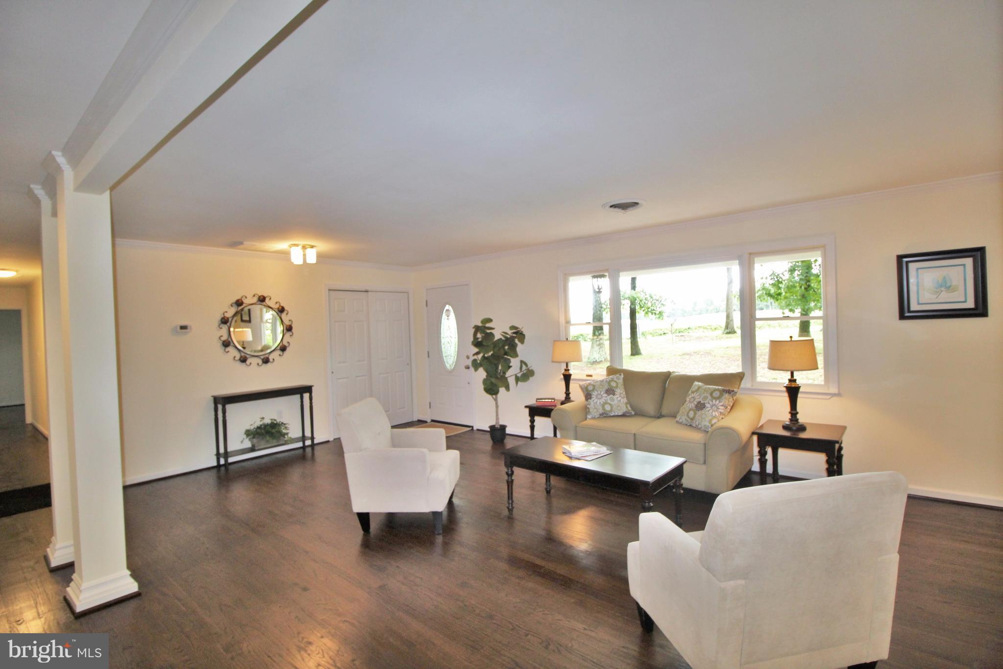 12919 Old Annapolis Road Mount Airy, MD 21771 - Photo 6 of 30 a living room with fireplace furniture and a wooden floor