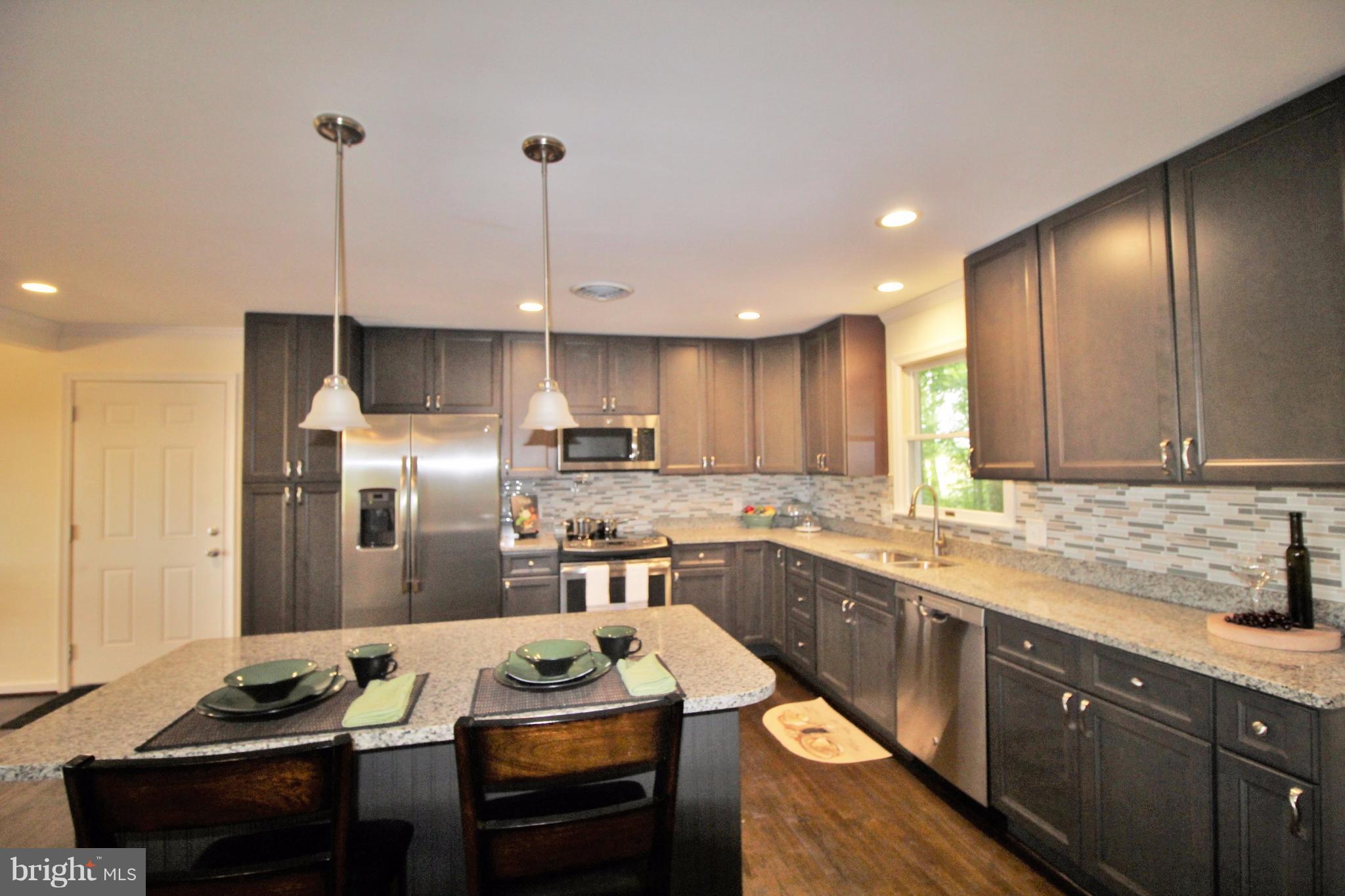 12919 Old Annapolis Road Mount Airy, MD 21771 - Photo 8 of 30 a kitchen with a sink stove and refrigerator