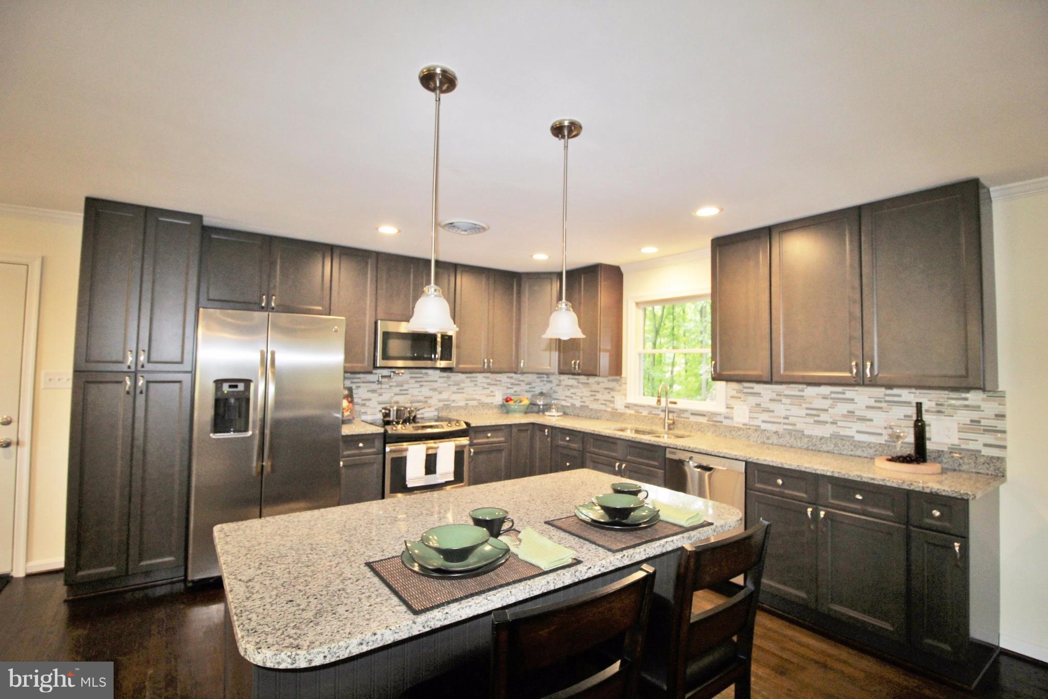 12919 Old Annapolis Road Mount Airy, MD 21771 - Photo 9 of 30 a kitchen with stainless steel appliances granite countertop a sink a stove a refrigerator and island