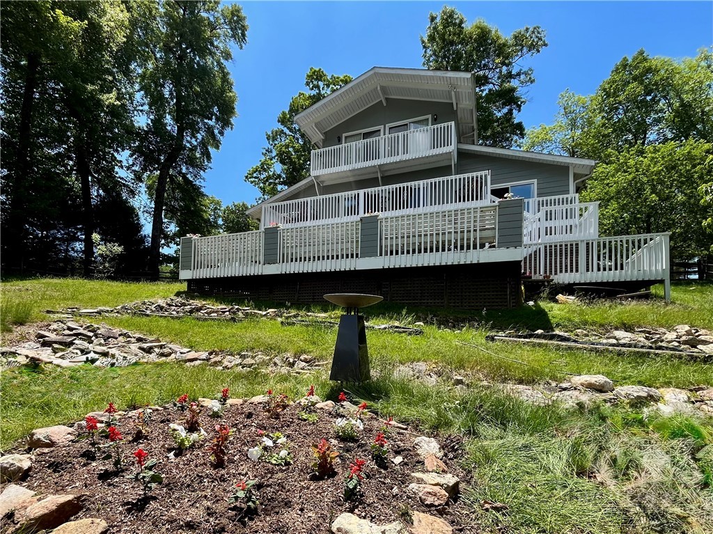 638 Ridge Road Glade Valley, NC 28627 - Photo 40 of 44 a view of a house with a yard and a garden