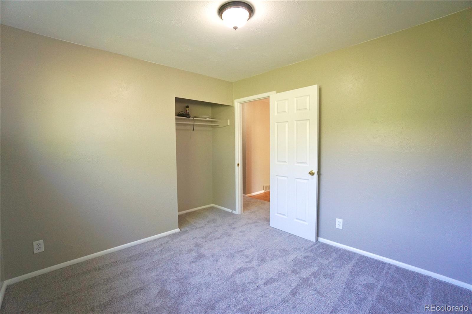 2519 15th Avenue Greeley, CO 80631 - Photo 17 of 25 an empty room with closet and mirror