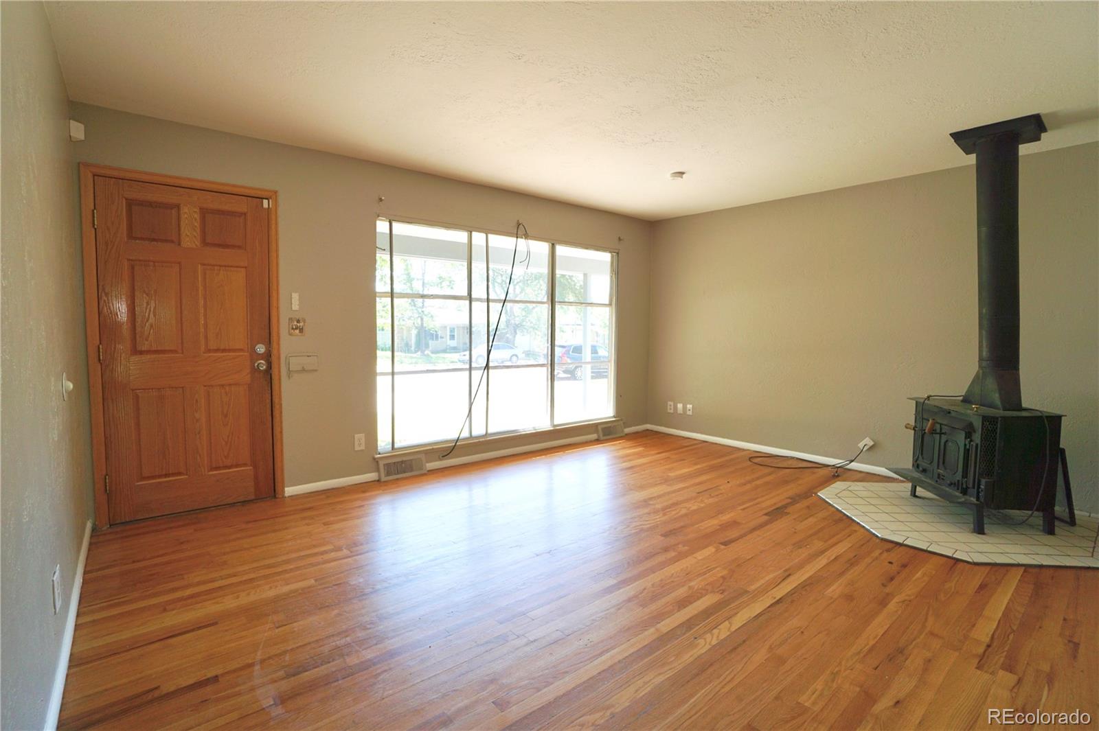 2519 15th Avenue Greeley, CO 80631 - Photo 4 of 25 a view of an empty room with wooden floor and a window