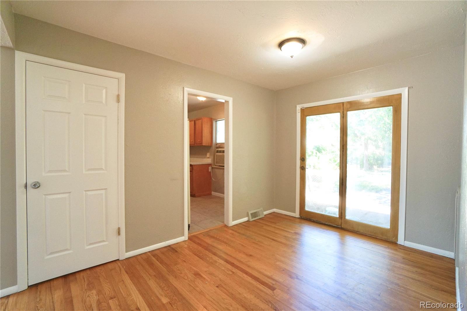 2519 15th Avenue Greeley, CO 80631 - Photo 8 of 25 a view of an empty room with wooden floor and a window