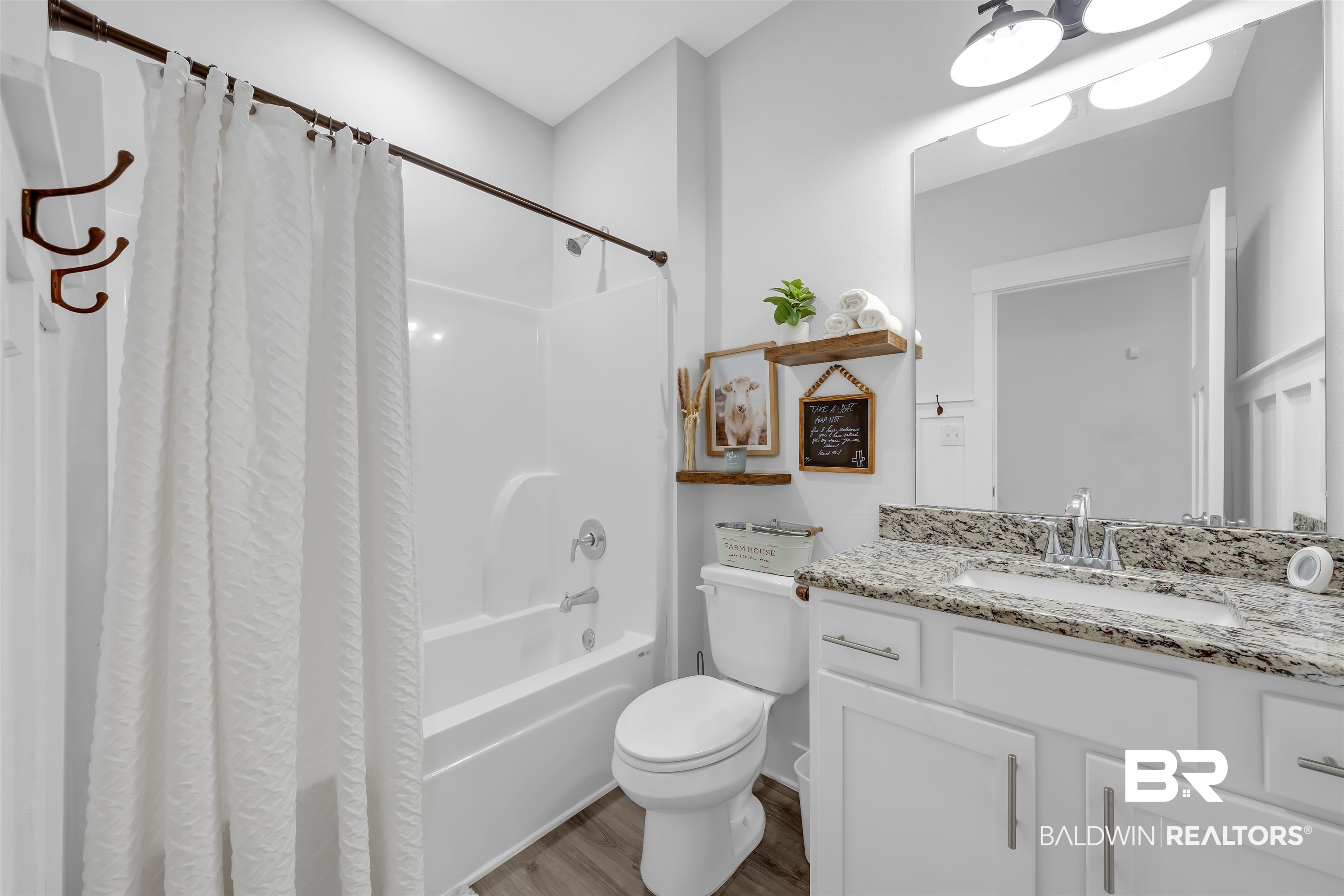 16504 Prado Loop Loxley, AL 36551 - Photo 21 of 45 Full bathroom featuring vanity, dark wood-style flooring, and shower / tub combo with curtain