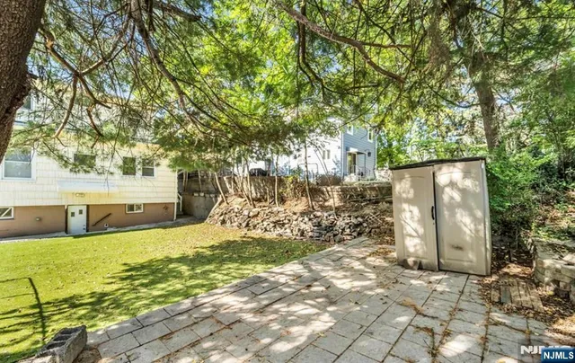 a view of a yard with wooden fence