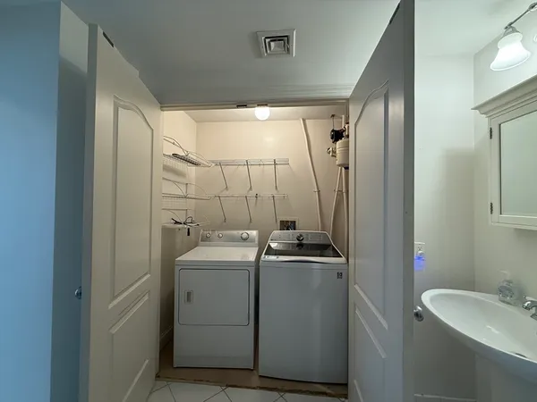 a bathroom with a sink toilet and mirror
