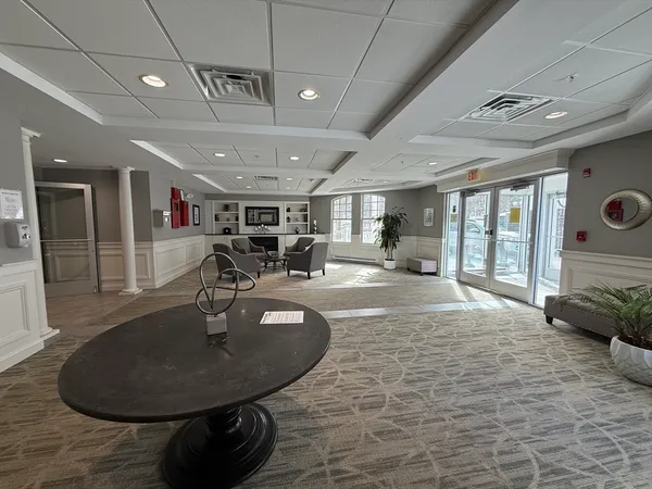 a lobby with furniture and a chandelier