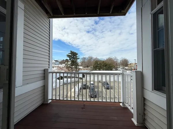 a view of balcony with wooden floor