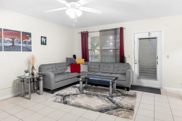 a living room with furniture and wooden floor