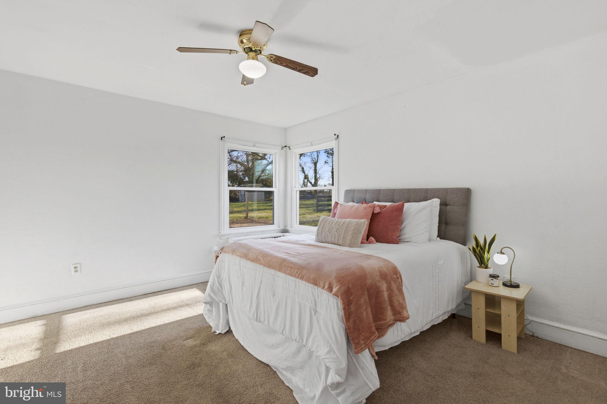 213 Groff Road Millington, MD 21651 - Photo 16 of 48 a bedroom with a bed and a chandelier