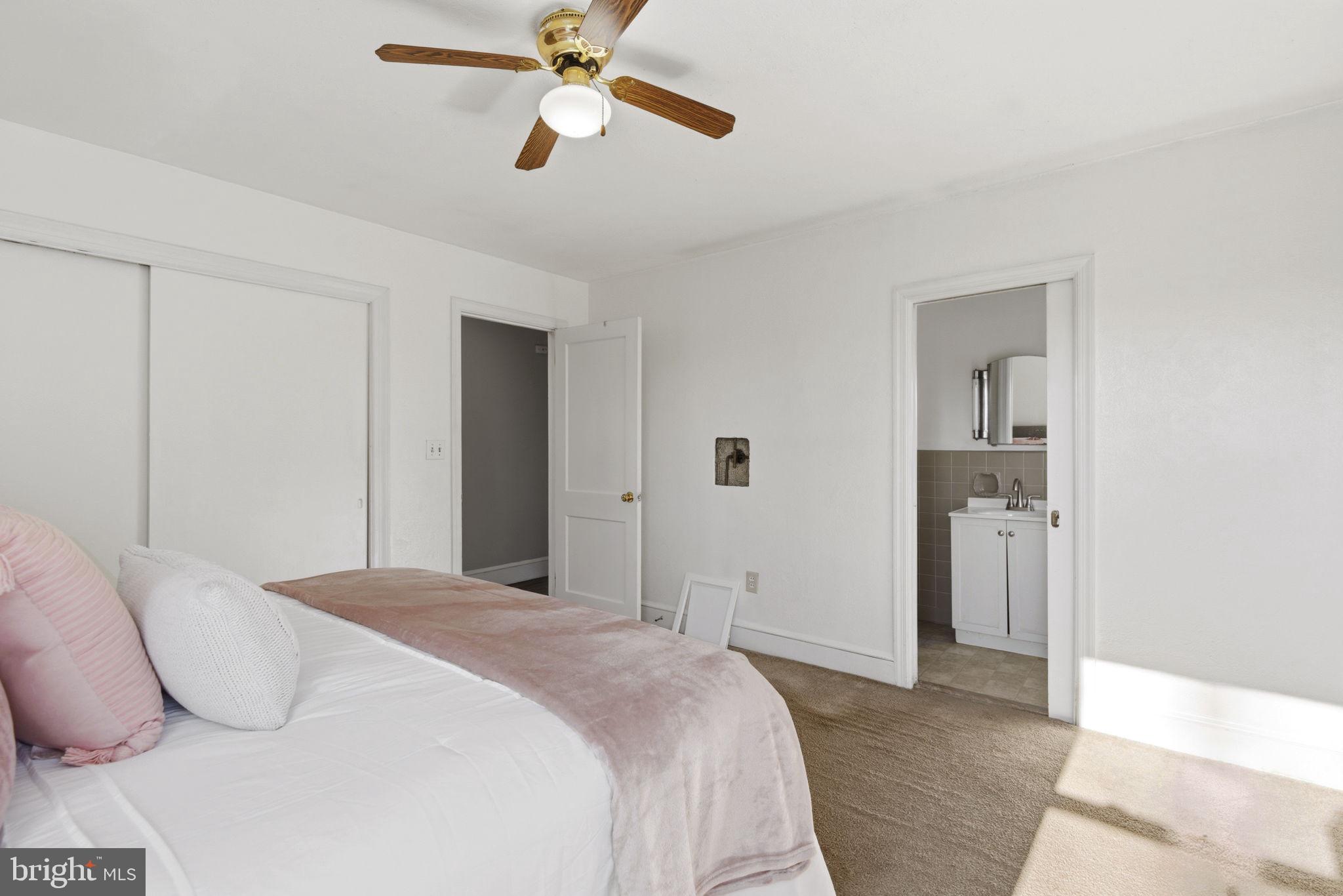 213 Groff Road Millington, MD 21651 - Photo 18 of 48 a bedroom with a bed and a chandelier