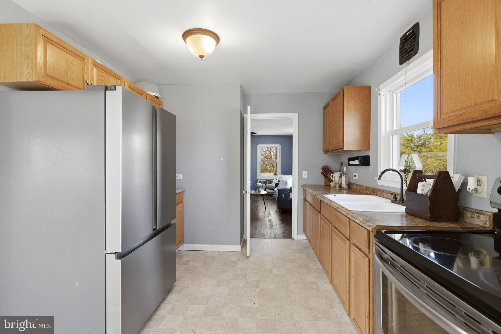 213 Groff Road Millington, MD 21651 - Photo 6 of 48 a kitchen with stainless steel appliances granite countertop a refrigerator and a sink