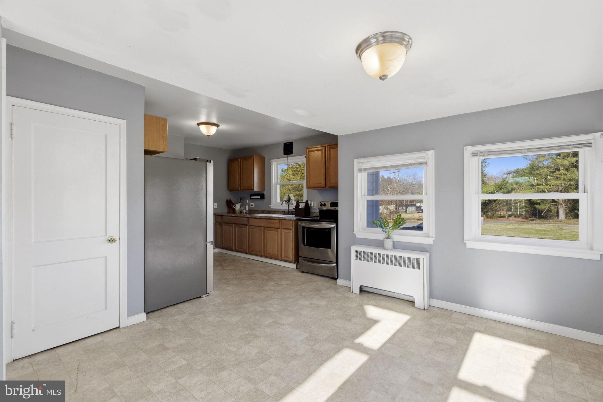 213 Groff Road Millington, MD 21651 - Photo 10 of 48 a view of a kitchen with wooden floor and a refrigerator