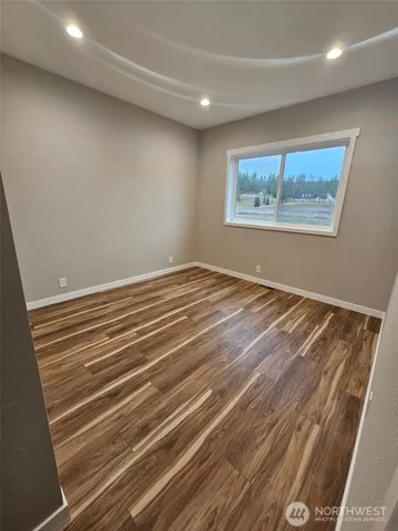 a view of a room with wooden floor and cabinet
