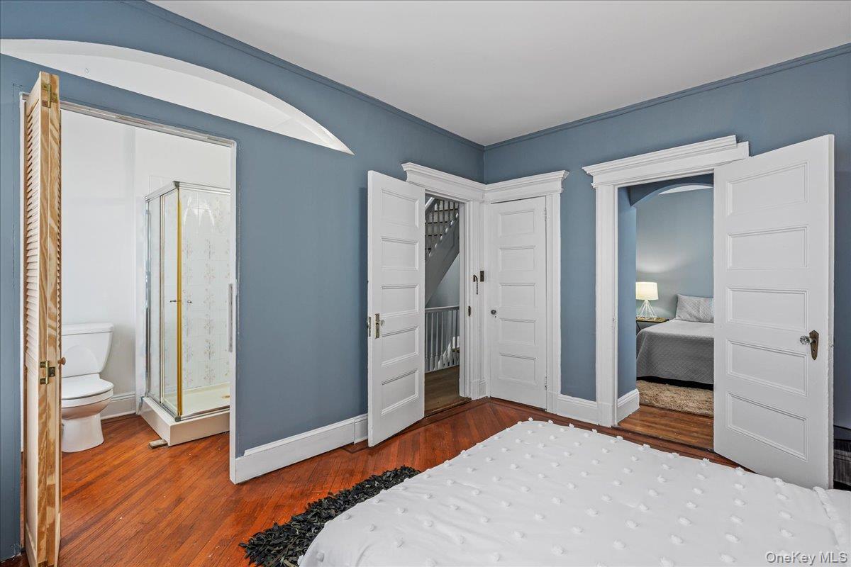196-19 89th Road Queens, NY 11423 - Photo 11 of 28 a bedroom with a bed and a bathroom