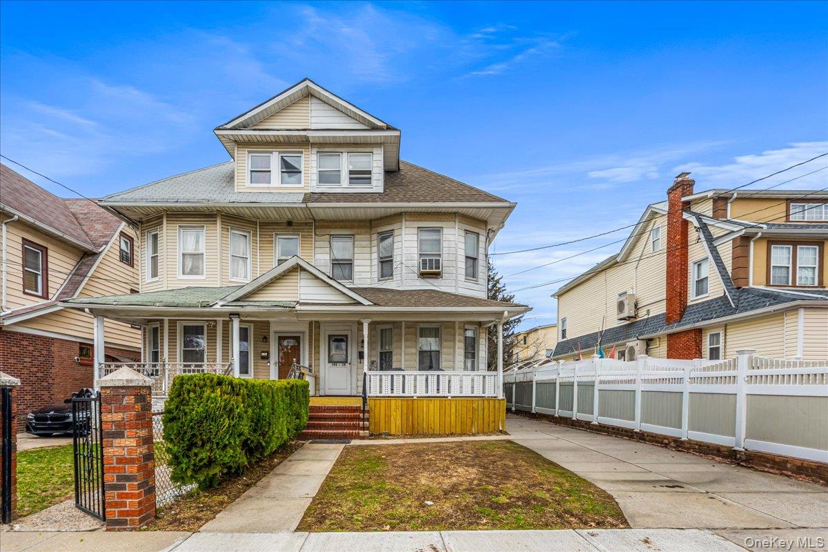 196-19 89th Road Queens, NY 11423 - Photo 24 of 28 a front view of a house with a yard