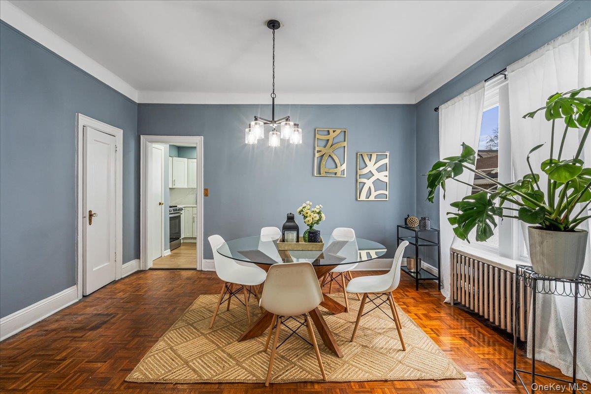 196-19 89th Road Queens, NY 11423 - Photo 5 of 28 a dining room with furniture potted plants and wooden floor