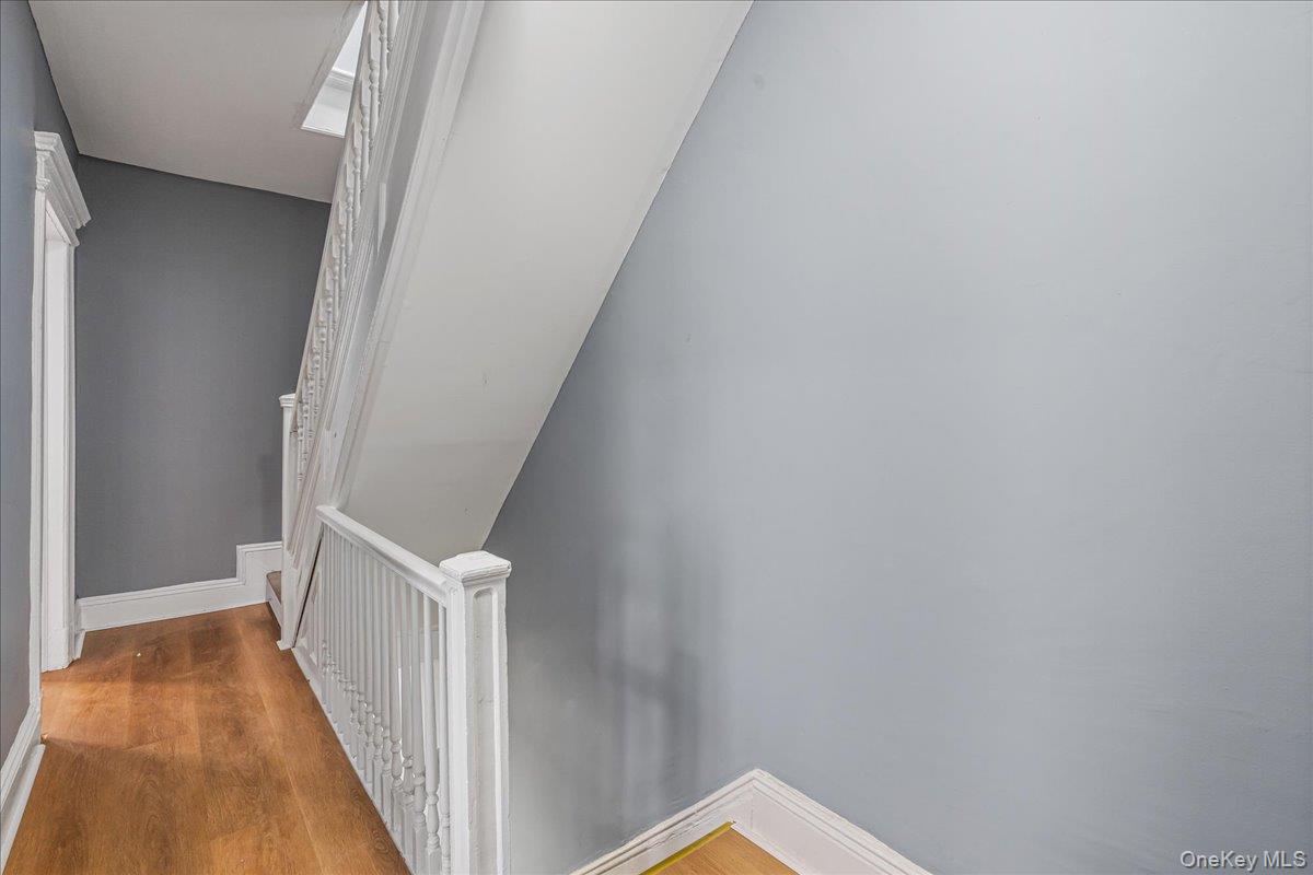 196-19 89th Road Queens, NY 11423 - Photo 9 of 28 a view of a hallway with wooden floor and entryway