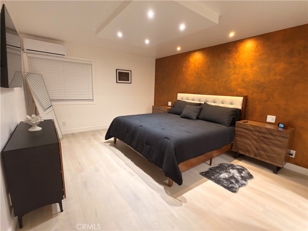 1140 Pacific Avenue, Unit 7 Long Beach, CA 90813 - Photo 11 of 21 a bedroom with a bed and couch