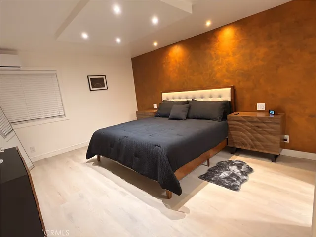 a bedroom with a bed and a night stand