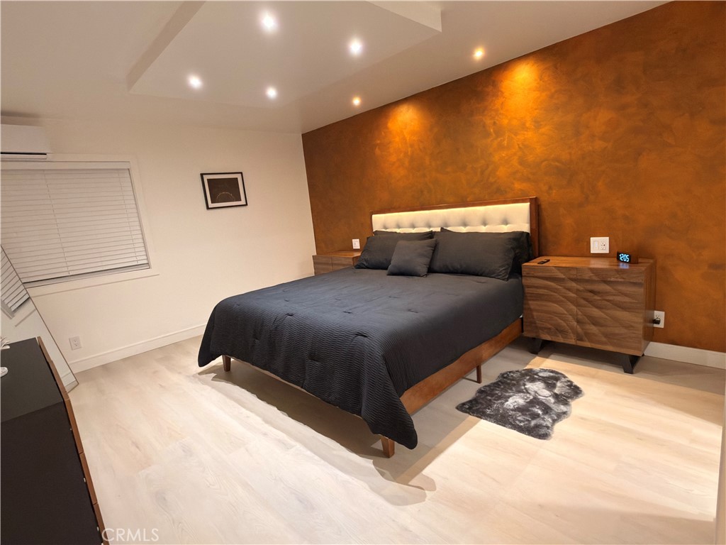 1140 Pacific Avenue, Unit 7 Long Beach, CA 90813 - Photo 13 of 21 a bedroom with a bed and a night stand