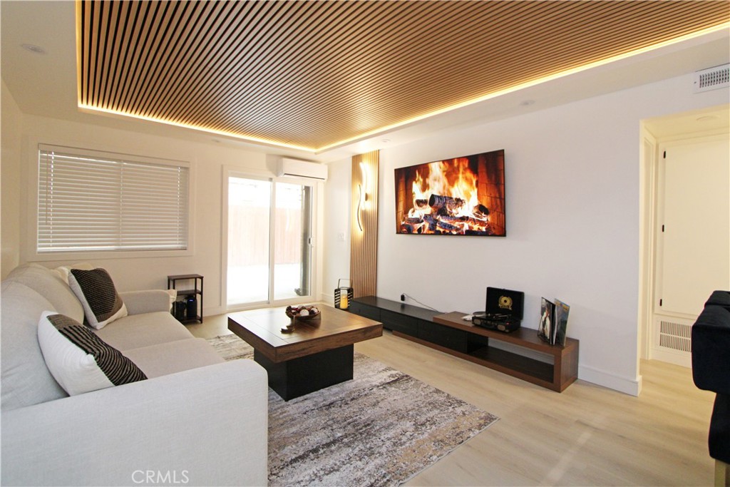1140 Pacific Avenue, Unit 7 Long Beach, CA 90813 - Photo 3 of 21 a living room with furniture and a flat screen tv