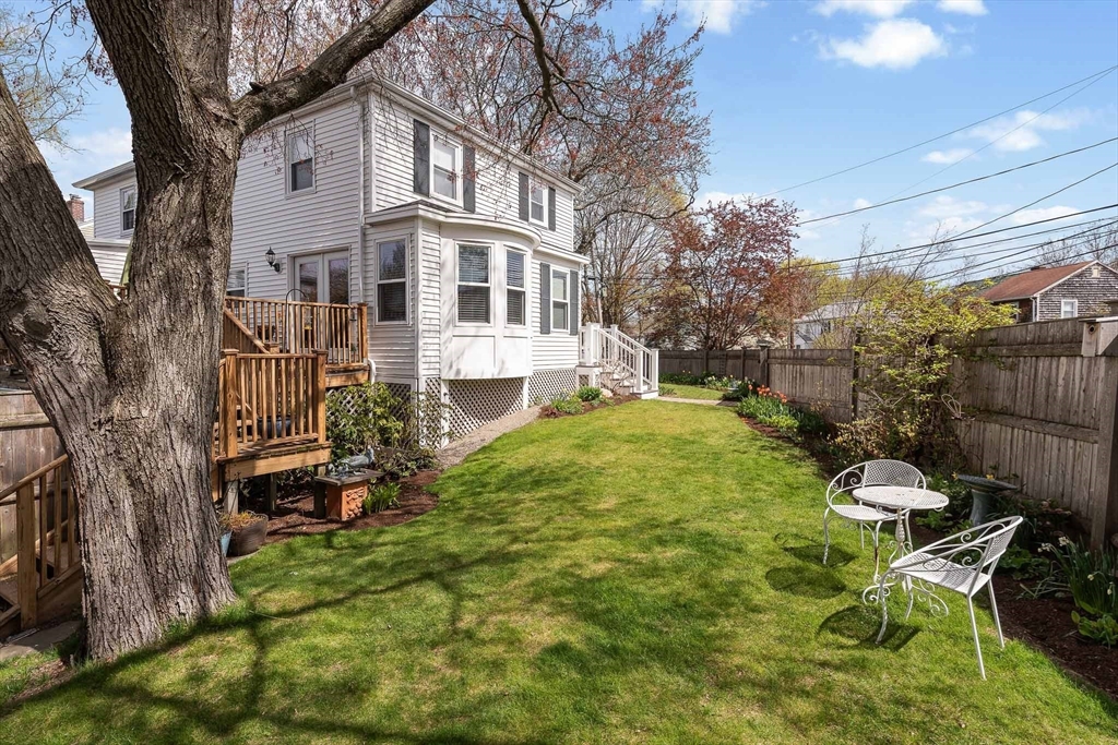 75 Fremont Street Arlington, MA 02474 - Photo 19 of 20 a view of a patio with table and chairs with wooden fence and plants