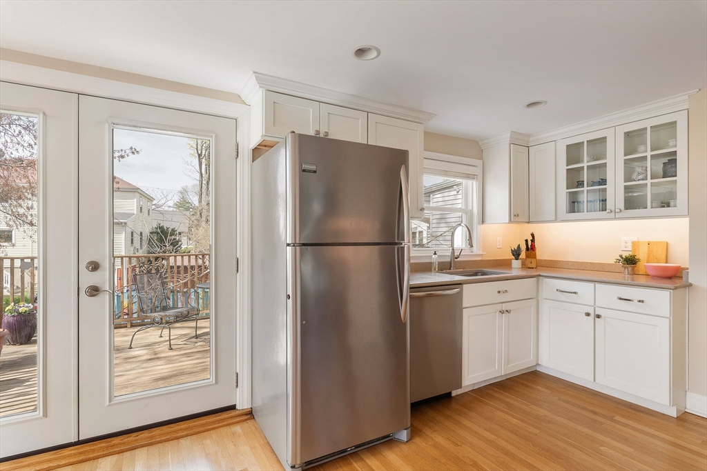 75 Fremont Street Arlington, MA 02474 - Photo 9 of 20 a kitchen with a refrigerator a sink and cabinets