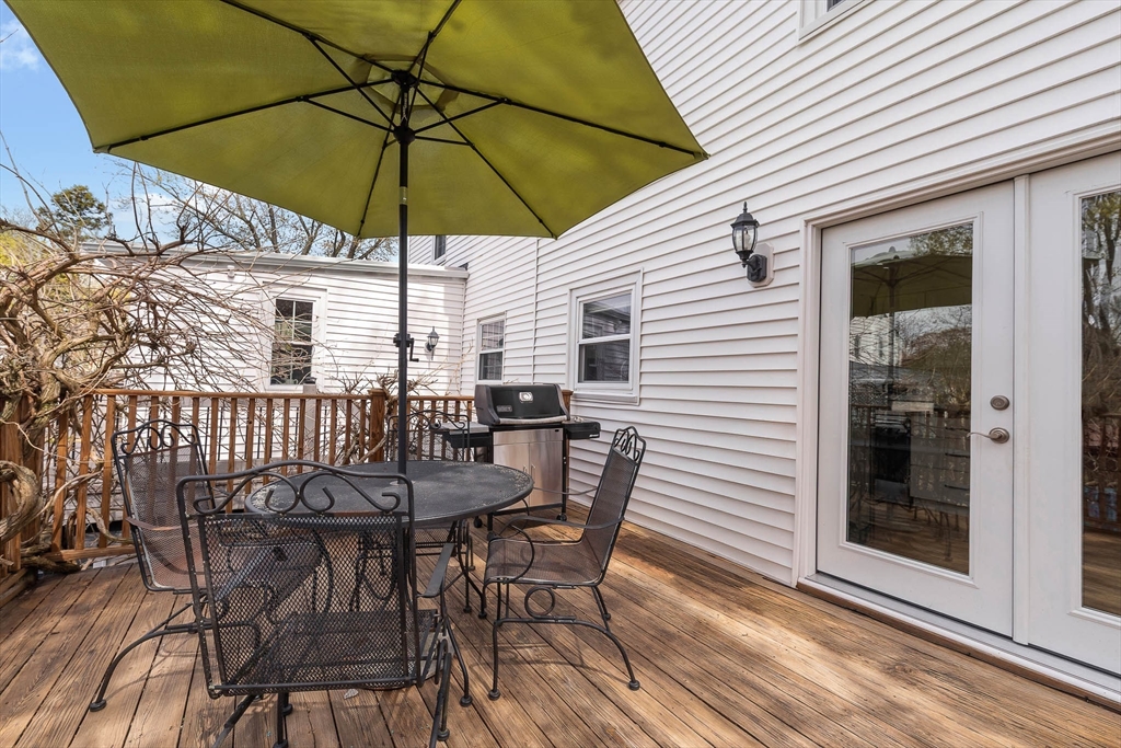 75 Fremont Street Arlington, MA 02474 - Photo 10 of 20 a view of a patio with table and chairs under an umbrella