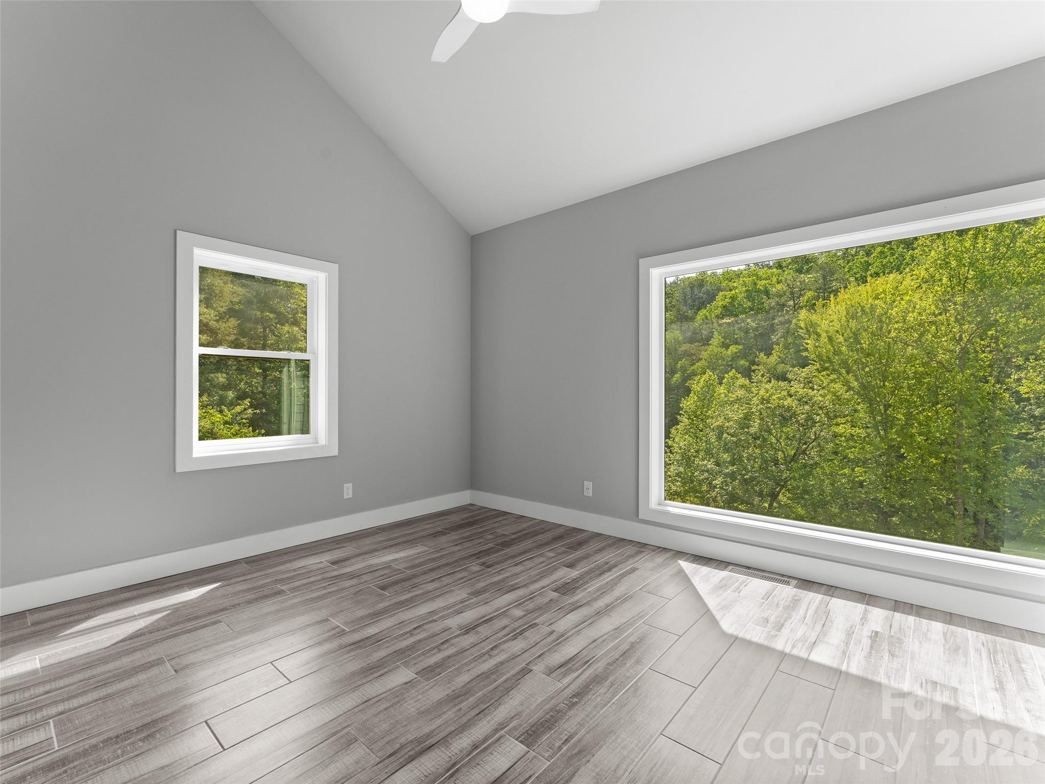 123 Israel Road Candler, NC 28715 - Photo 28 of 44 a view of an empty room with wooden floor and a window