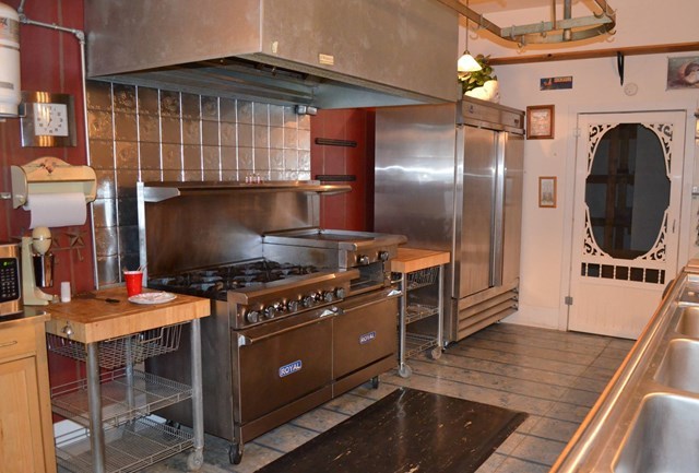 429 Hudson Jones Road Cochran, GA 31014 - Photo 11 of 45 a kitchen with stainless steel appliances granite countertop a stove a sink and a refrigerator
