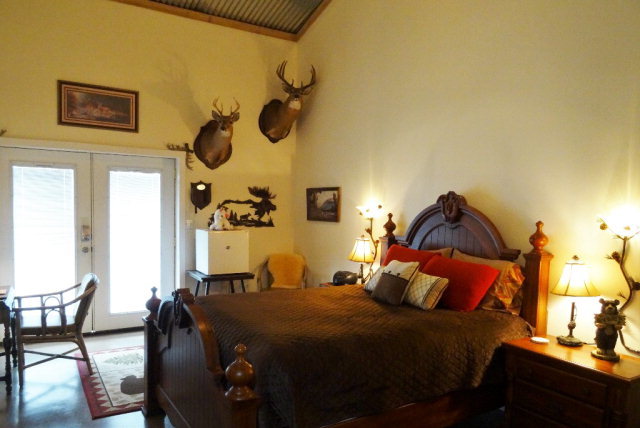 429 Hudson Jones Road Cochran, GA 31014 - Photo 16 of 45 a bedroom with a bed and wooden floor