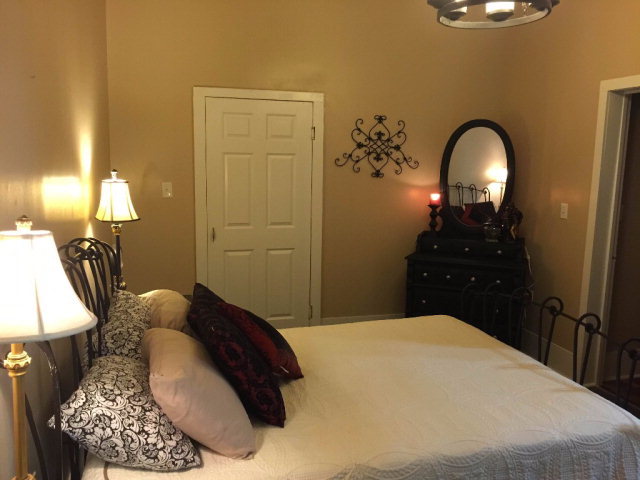 429 Hudson Jones Road Cochran, GA 31014 - Photo 18 of 45 a bedroom with a bed and a chandelier