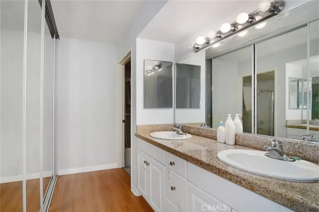 a bathroom with a double vanity sink and a mirror