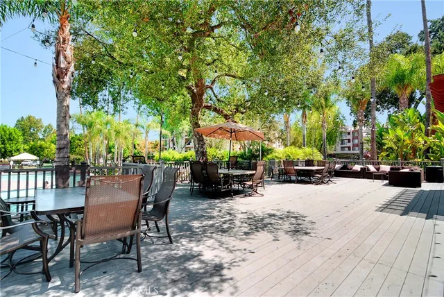 a view of a patio with a table and chairs and potted plants