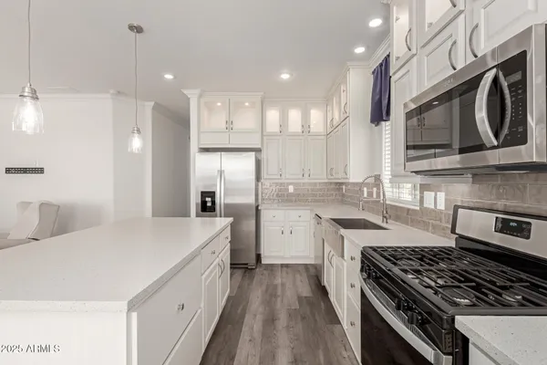 a kitchen with a sink stove and refrigerator