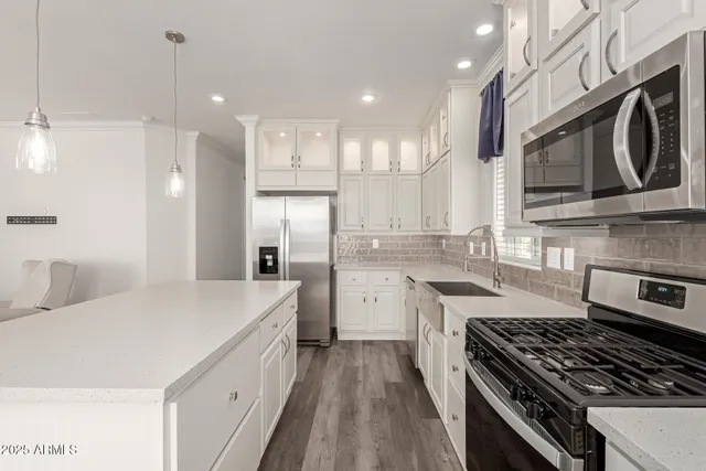 a kitchen with a sink stove and refrigerator
