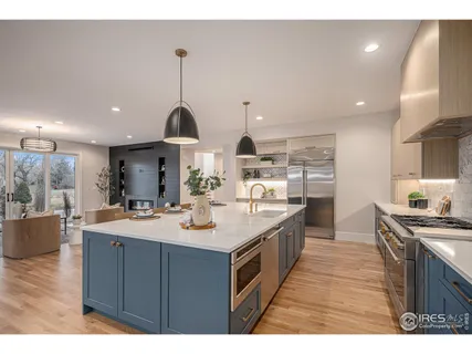 a kitchen with kitchen island granite countertop a stove and a sink