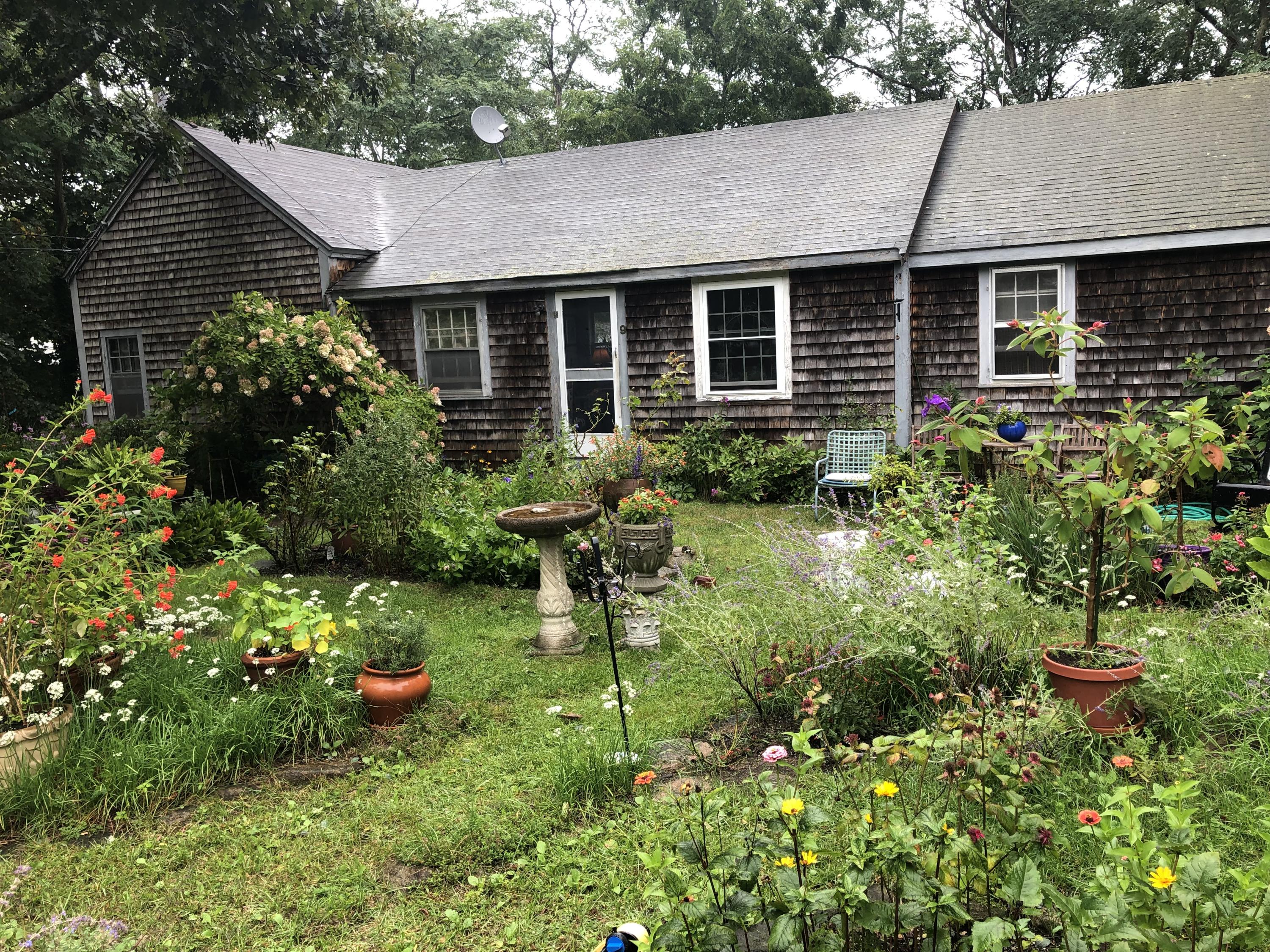 a backyard of a house with table and chairs