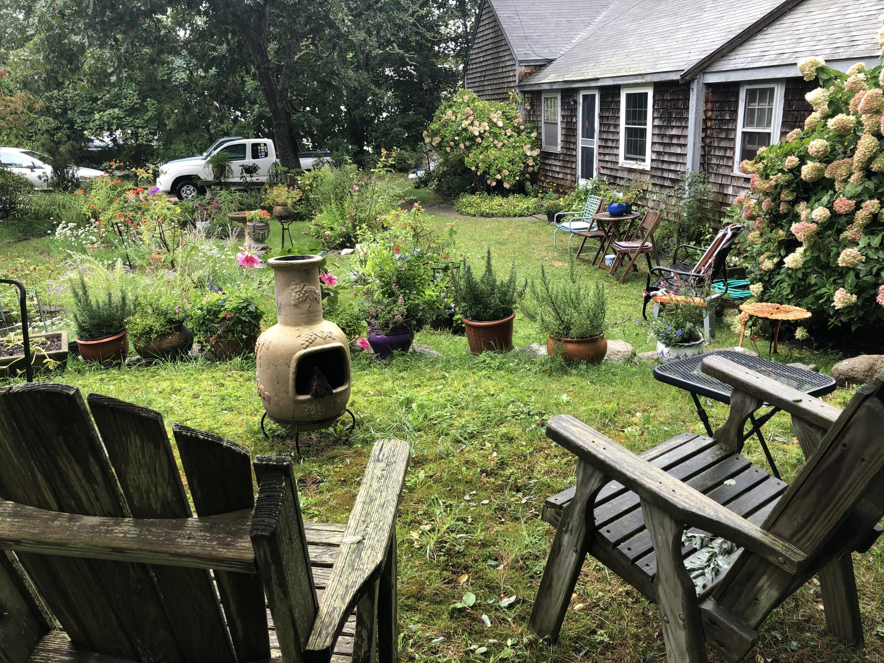 9 Childs Homestead Road Orleans, MA 02653 - Photo 3 of 19 a view of a chairs and table in patio with a yard