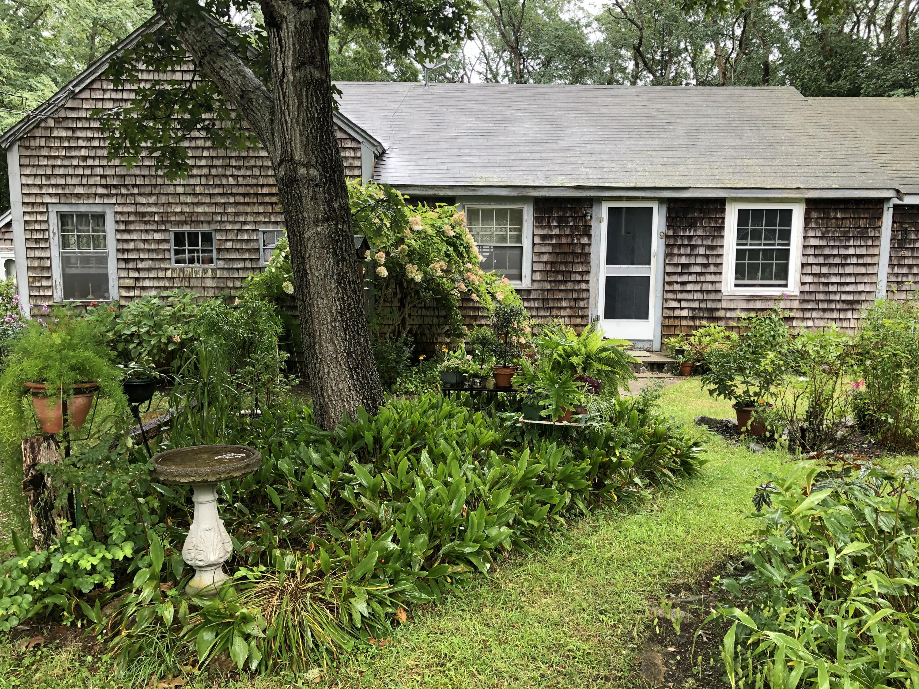 9 Childs Homestead Road Orleans, MA 02653 - Photo 5 of 19 a front view of a house with garden