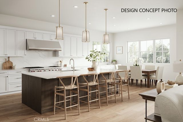 a kitchen with a dining table chairs sink and stove