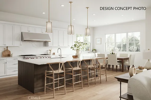 a kitchen with a dining table chairs sink and stove